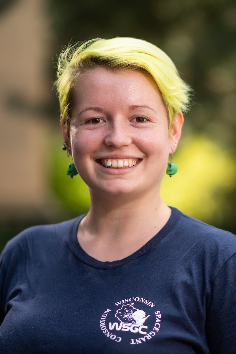 Smiling person with bright yellow hair